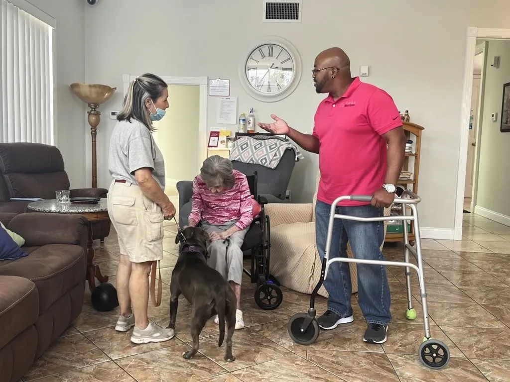 Staff member reassuring family members during a care discussion