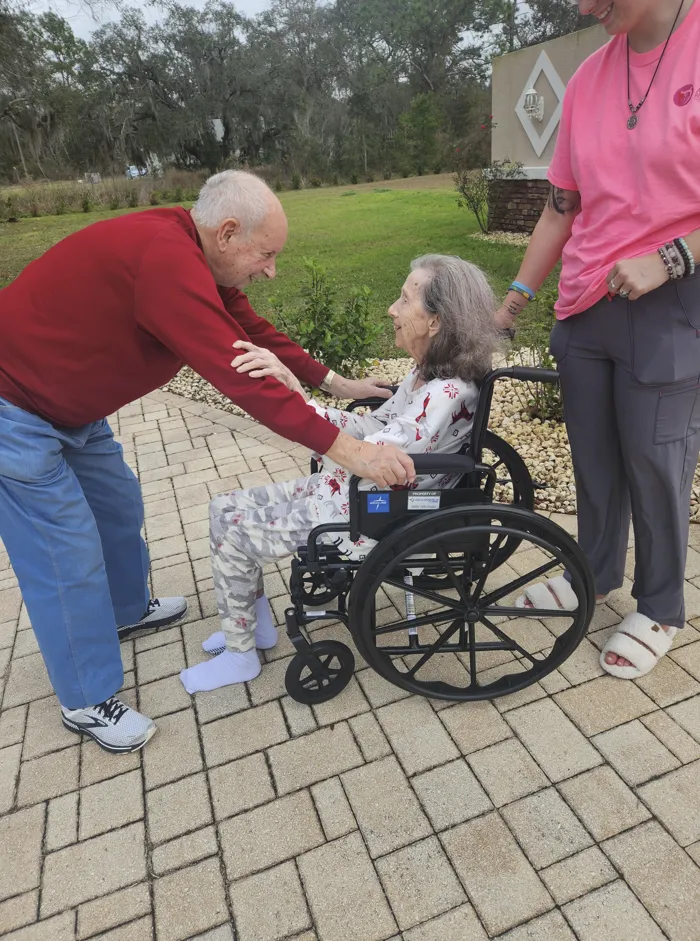 Caregiver and elderly resident discussing personalized care plans in a warm, supportive environment